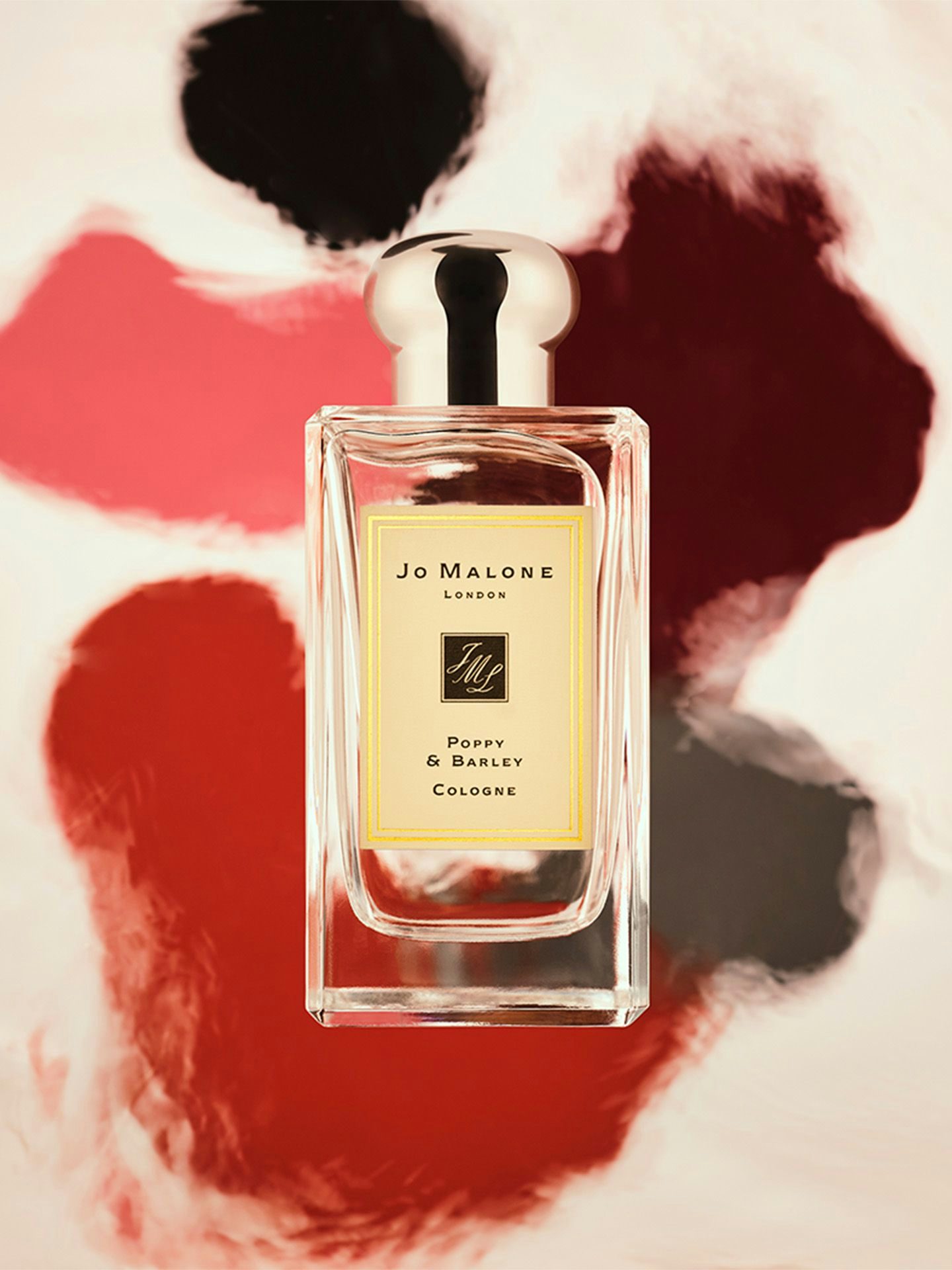A Jo Malone perfume bottle appears to float above blurred color spots.