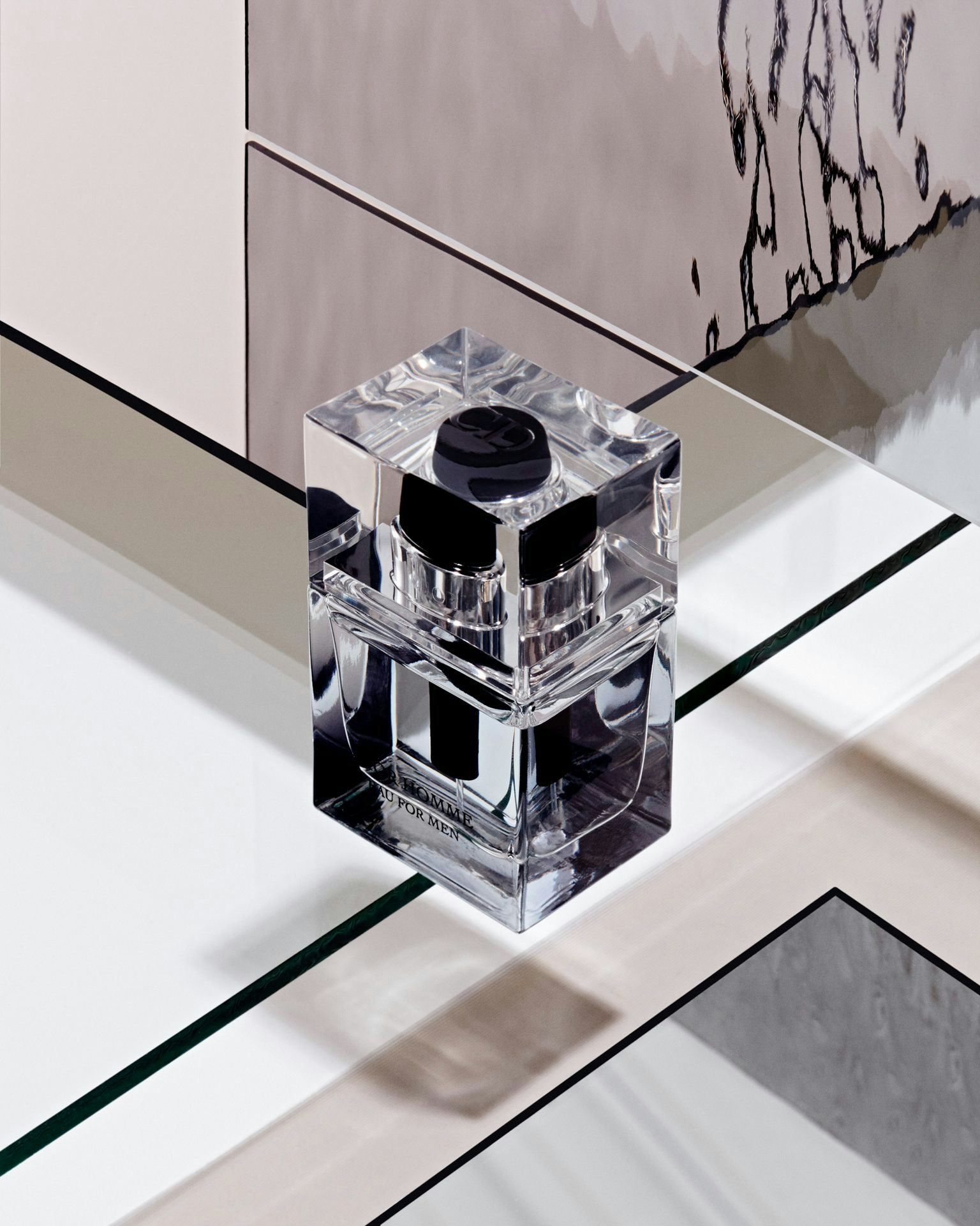 A glass perfume bottle in a geometric setting.