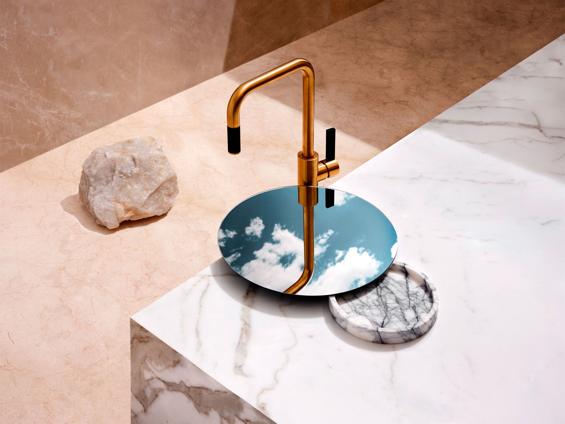 A tin faucet and a mirror reflecting a beautiful blue sky.
